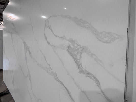 Marble-like quartz surface with gray veining on a white background
