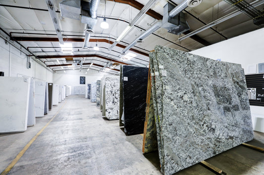Rows of stone slabs on the warehouse floor at Marbino Surfaces in Phoenix, Arizona
