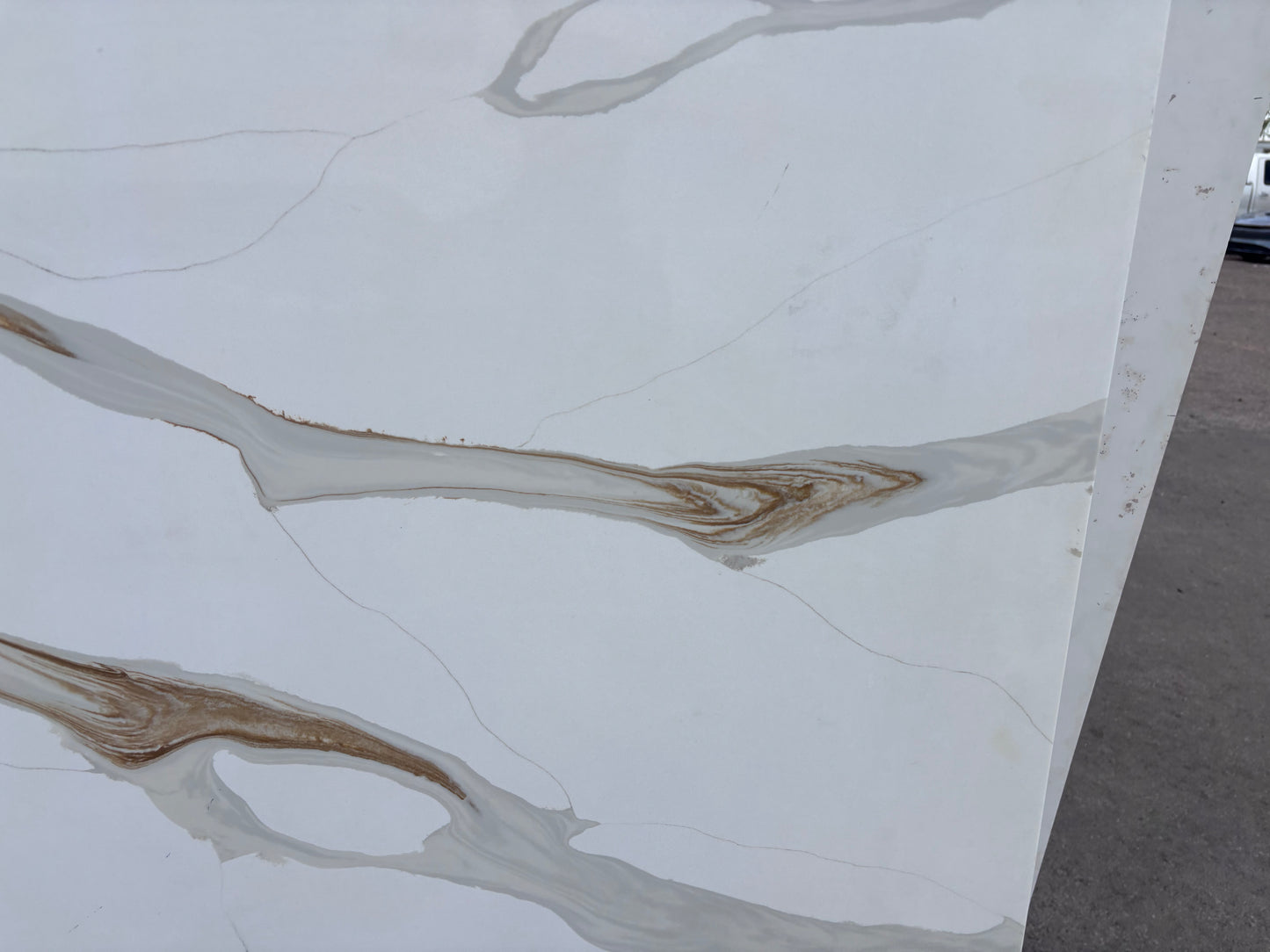 Marble-patterned quartz with brown veins on a white background