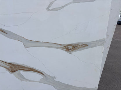 Marble-patterned quartz with brown veins on a white background