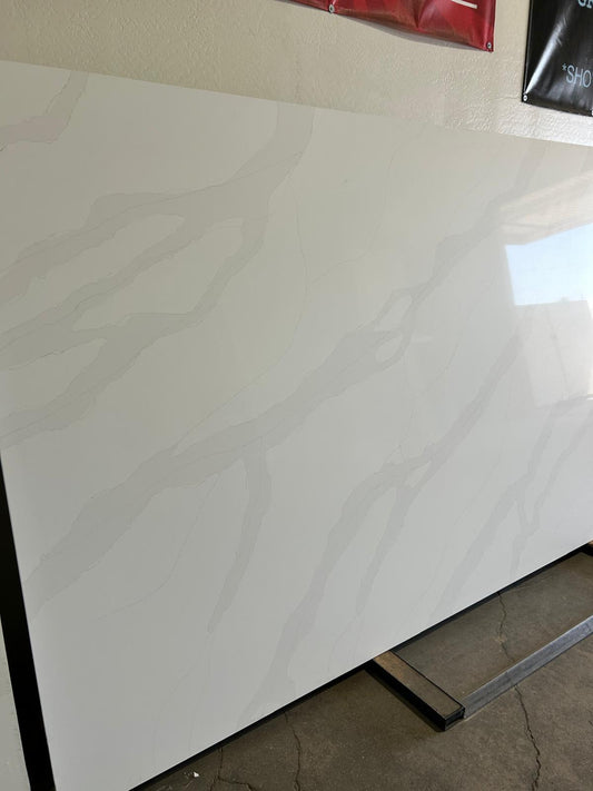 Super Jumbo White quartz countertop with light gray veins flowing through the material combining a minimalist look