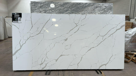 Gold and Gray veining on white quartz. A modern marble look perfect for your kitchen.