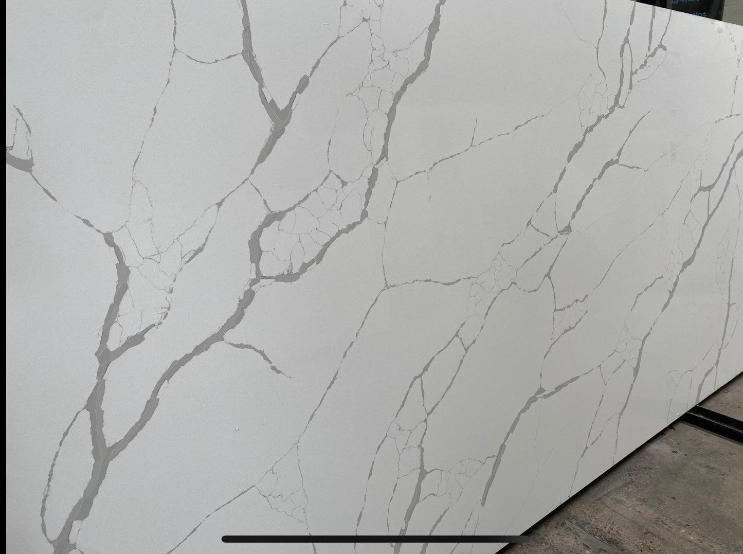 Black and gray veins on white background quartz countertop. Modern European look for your kitchen.