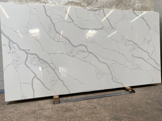 Fancy 3CM white quartz countertop slab with busy gray veining.